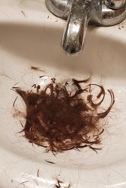 Scraps of my hair in a sink.