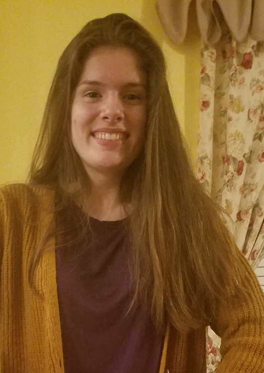 Me with long hair in an orange sweater.